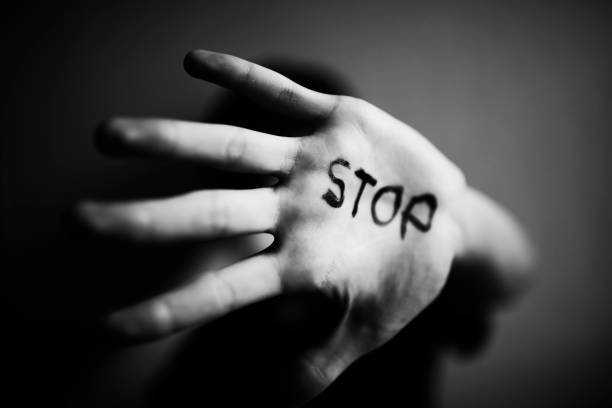 istock A 18-year-old guy protects himself with his hand with the inscription Stop 1170974521