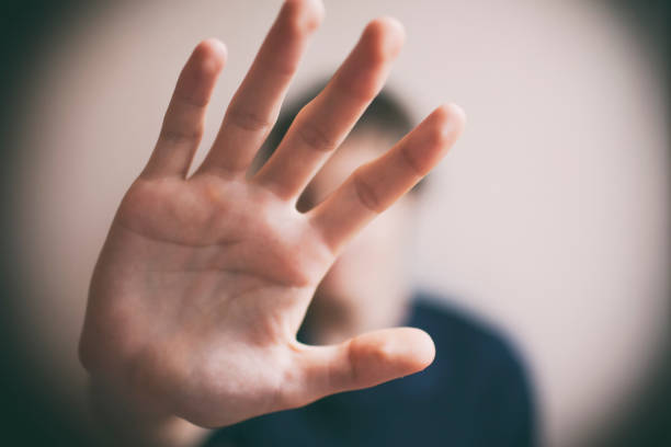 istock 18 years old guy defends himself with his palm 1170974535