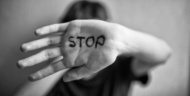 istock A 18-year-old guy protects himself with his hand with the inscription Stop 1170974536