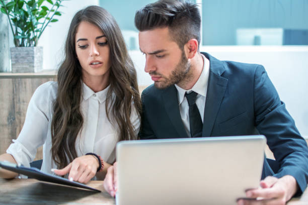 istock Attractive secretary working with handsome businessman in office 1170978520