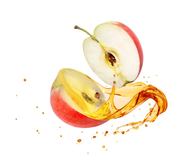 istock Juice splashes out from sliced apple on white background 1170978540