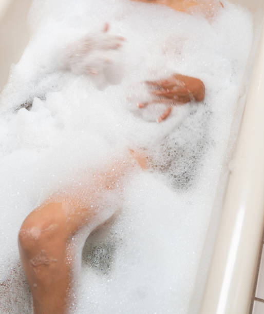 istock Woman taking bubble bath with brass faucet 1170979445