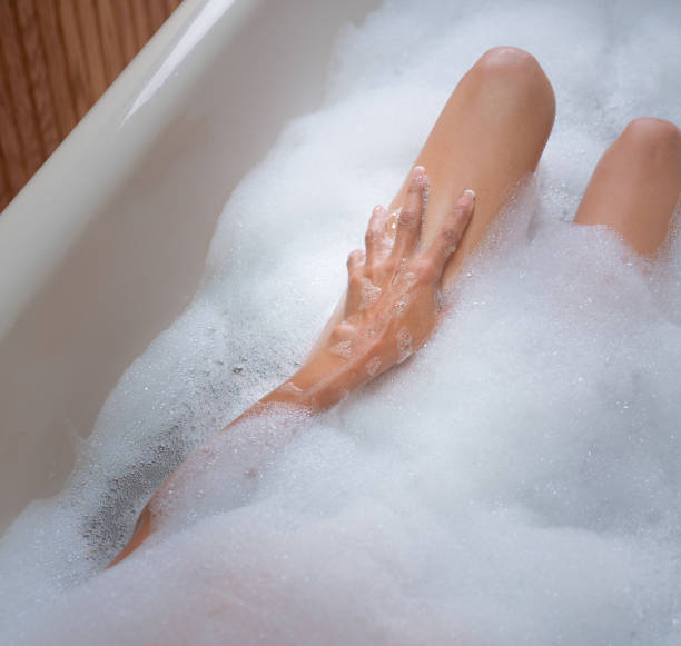 istock Woman taking bubble bath with brass faucet 1170979449