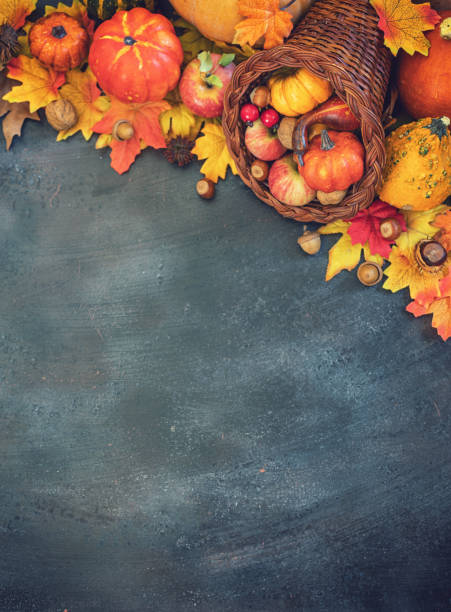 istock Decorated autumn cornucopia with pumpkins and leaves on the rustic background 1170981945