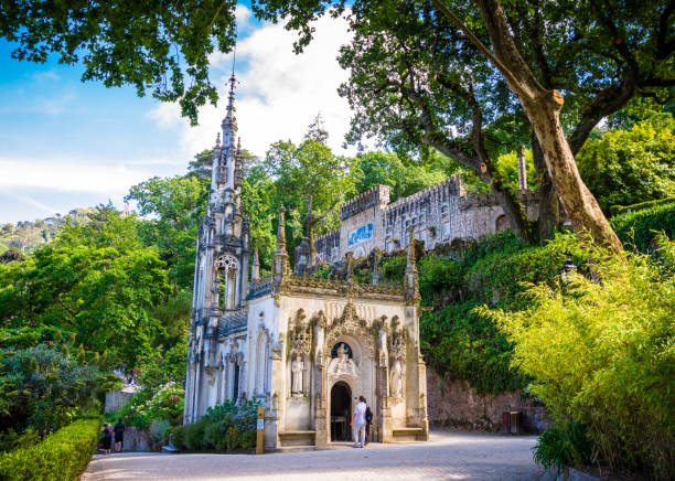 Tourists explore the Chapel of the Holy Trinity in Quinta da Regaleira in Sintra, Portugal stock photo