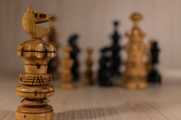 istock Chess pieces on wooden background 1170989836