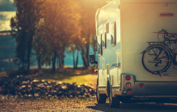 Fall RV Camper Camping Autumn RV Camping. Modern Camper Van During Late Sunny Fall Afternoon. Scenic RV Park. mobile home stock pictures, royalty-free photos & images