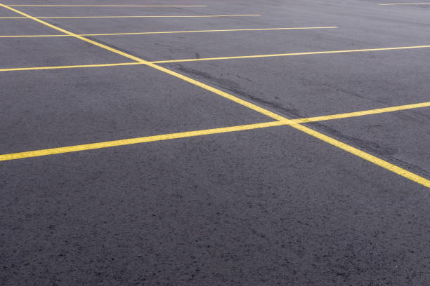 Freshly Paved Parking Lot A freshly paved asphalt parking lot in Michigan. freshly painted road markings stock pictures, royalty-free photos & images