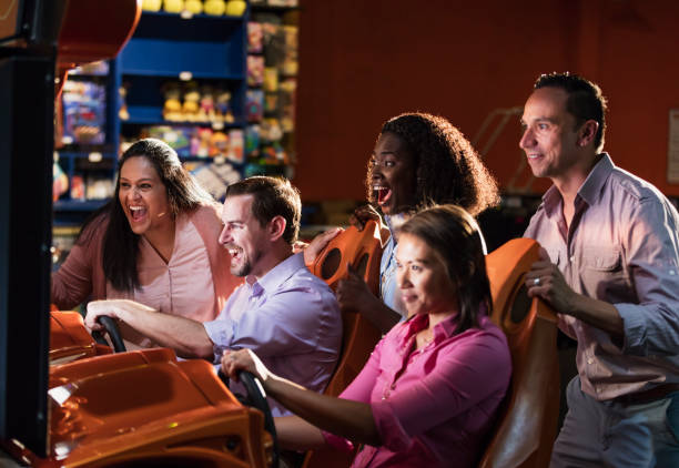 istock Team building at amusement arcade, playing racing game 1170991242