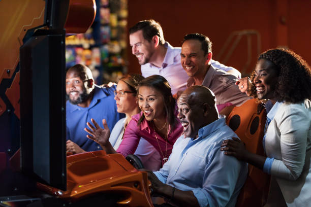 istock Team building at amusement arcade, playing racing game 1170991244