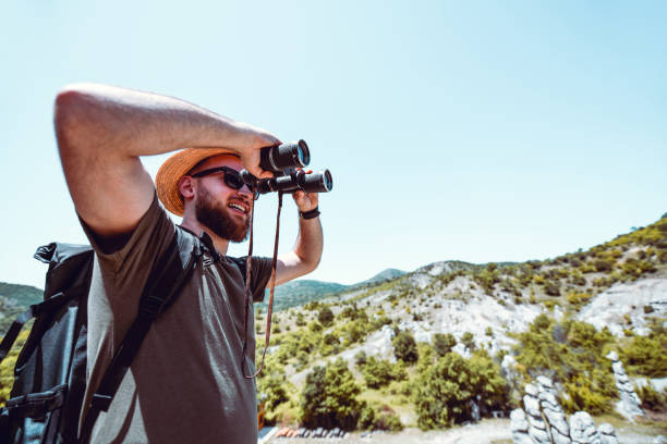 istock Male Looking At Terrain With Binoculars 1170994136