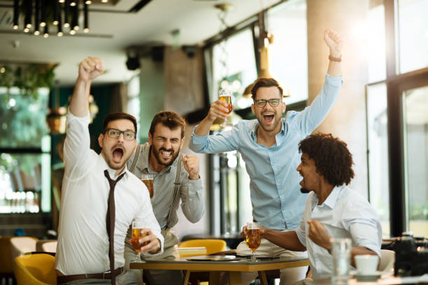 istock Friends are happy while watching game at te pub and drinking beer. 1170995166