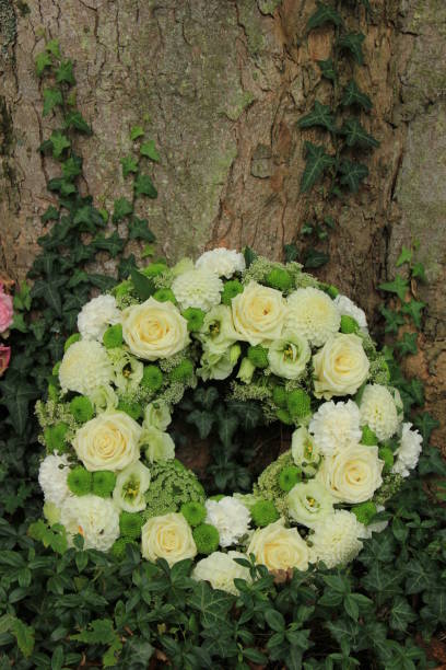 istock white sympathy wreath near a tree 1170995355