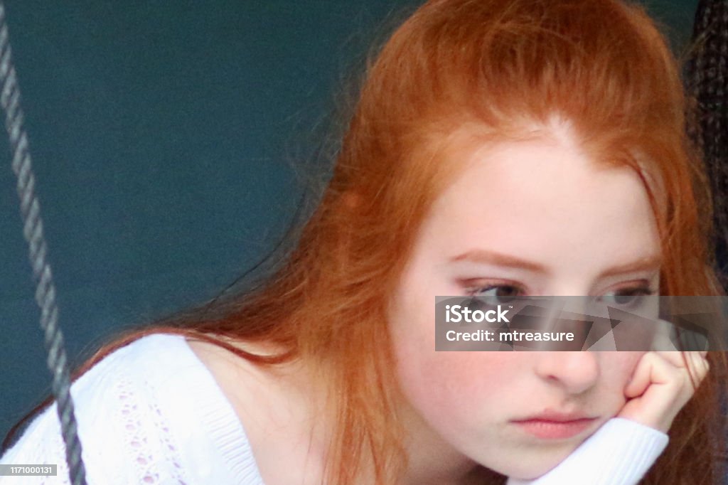 Image Of Red Haired Teenage Girl 14 15 With Hair In Ponytail And Chin  Leaning On Hand Looking Glum Bored And Fed Up Moody Teenager Photo Stock  Photo - Download Image Now - iStock