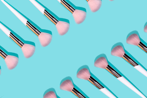 istock Pattern made of make up white brush on turquoise background. 1171001017
