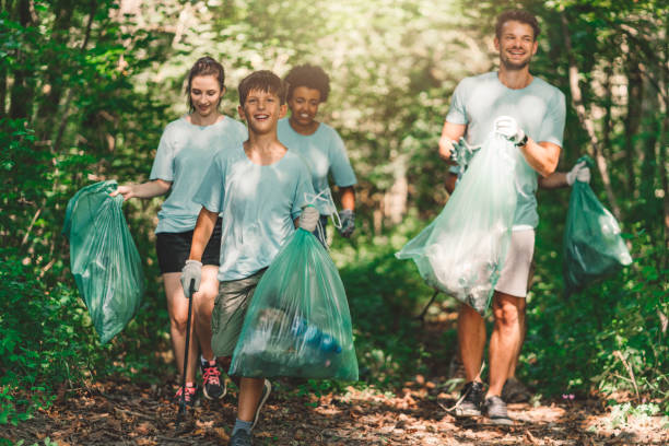 istock Happy people, volunteering to clean the forest 1171001908