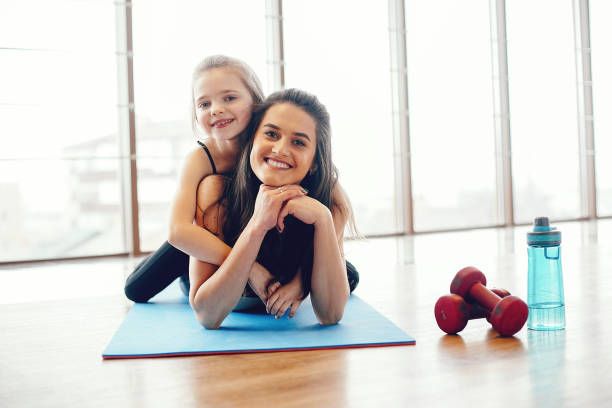istock Mother and daughter training in a gym 1171001957