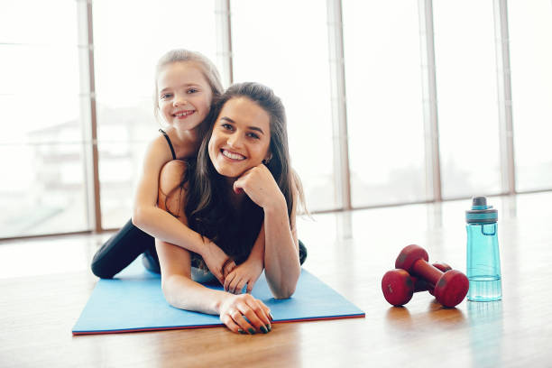 istock Mother and daughter training in a gym 1171001964