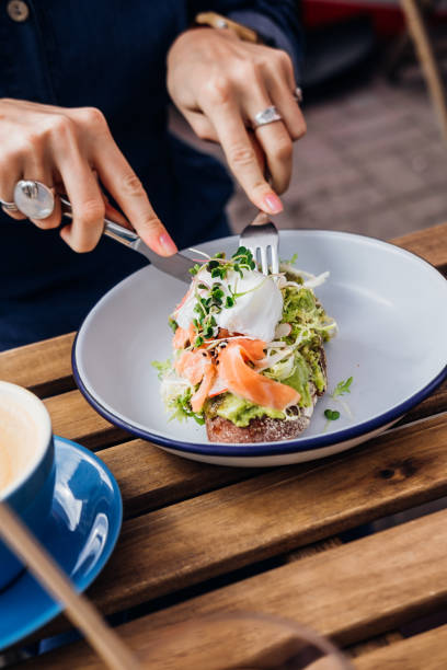 istock Woman hands cutting avocado toast 1171002078