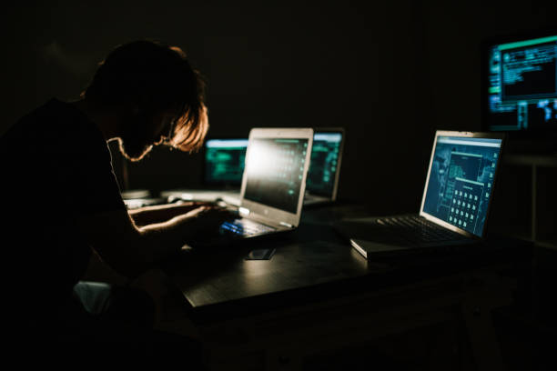 Hacker working in the dark room and stealing information