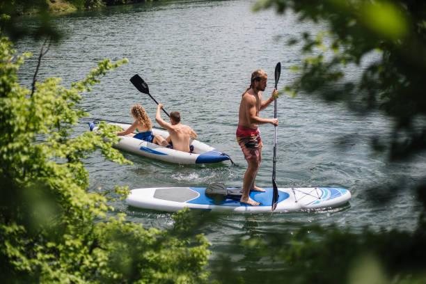 istock People enjoying the lake paddleboarding and kayaking 1171005752