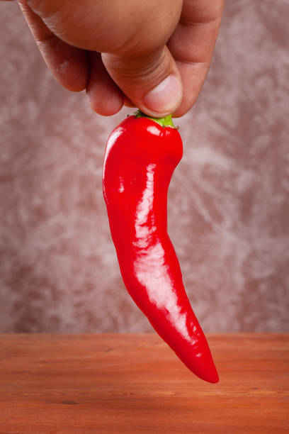 istock hot red chili pepper in hand 1171007761