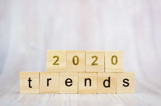 Photo of The word trends and 2020 on wooden cube block. 2020 trend concept