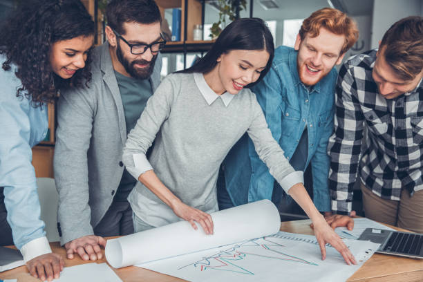 istock Startupers working together at office standing near table looking at performance graph cheerful 1171009897