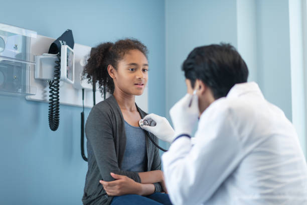 istock Mixed-race elementary age girl has heart checked by doctor 1171010284