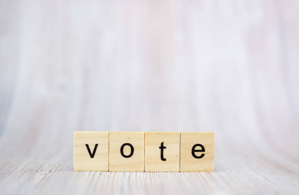 istock The word Vote on wooden cube block on wood table 1171010346