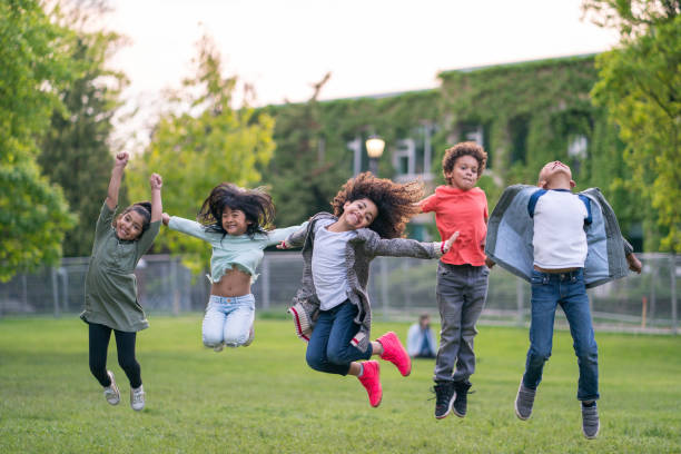 istock A group of kids jumping in the park 1171011020