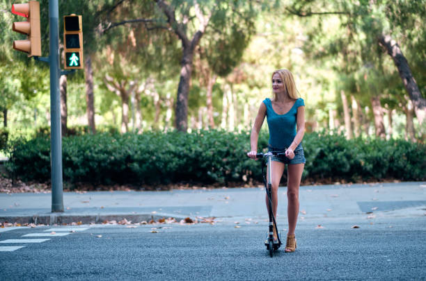 istock a young pretty woman using an electric scooter - transportation concept 1171011244