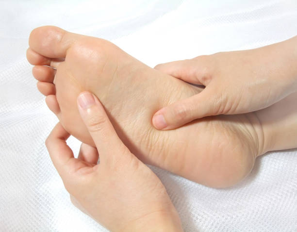 Foot massage Massaging the sole of the foot with fingers. pressure point photos stock pictures, royalty-free photos & images