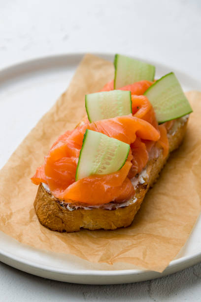 istock Bruschetta with salmon and cheese and cucumber on white concrete table 1171013150