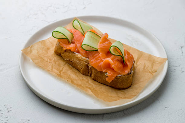 istock Bruschetta with salmon and cheese and cucumber on white concrete table 1171013168