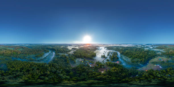 360-degree panoramic aerial view of the field, forest and river covered with a thick layer of morning fog