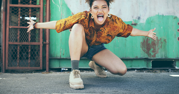 Shot of an attractive young woman having fun on the sidewalk in an urban town