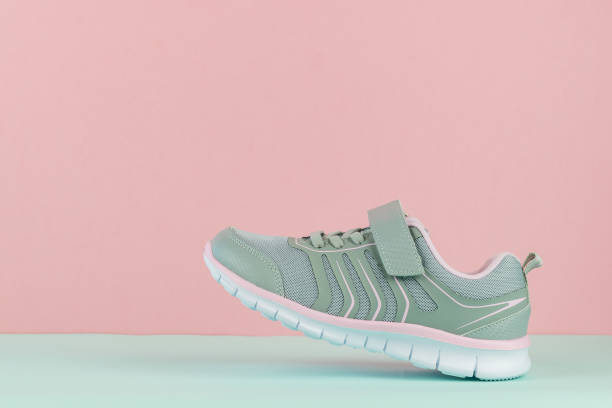 istock Walking sneaker with left foot on blue and pink background. 1171024668