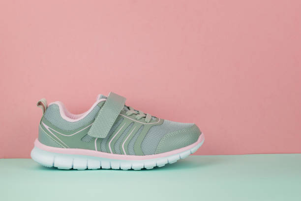 istock Gray sneaker on the right foot on a blue and pink background. 1171024679