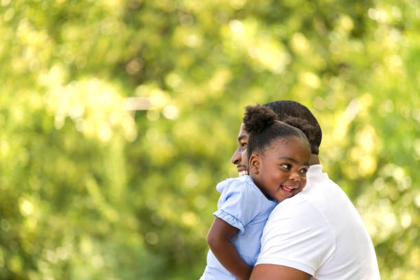 istock African American father hugging her daughter. 1171027170