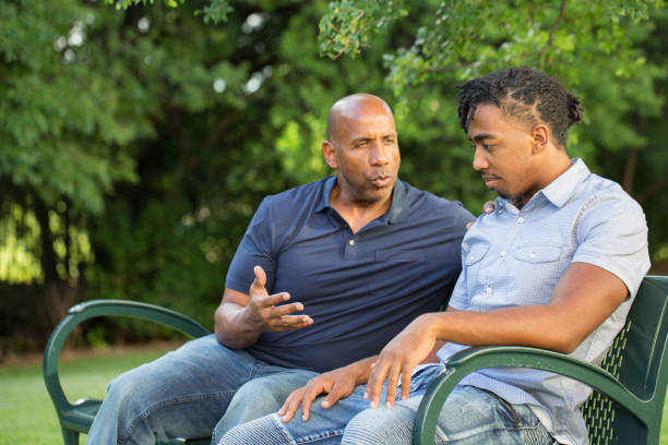 African American father and his son. Portrait of an African American father and his son. serious black teen stock pictures, royalty-free photos & images