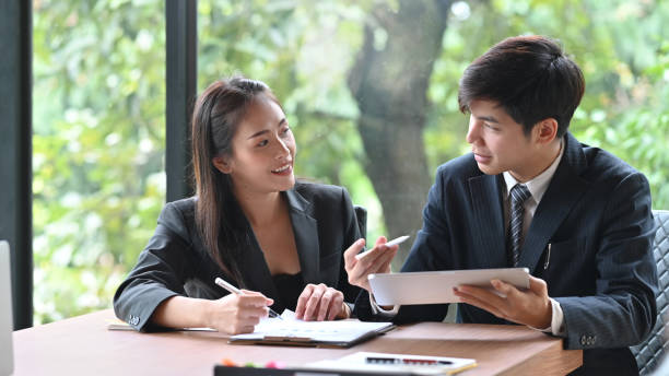 istock Young asian business people meeting with tablet on office table. 1171029758