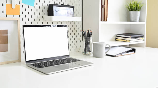 istock Mockup laptop computer pegboard and shelves with office supplies. 1171029819