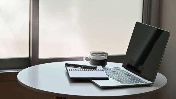 istock Laptop, notebook, pen and coffee on table. 1171030027