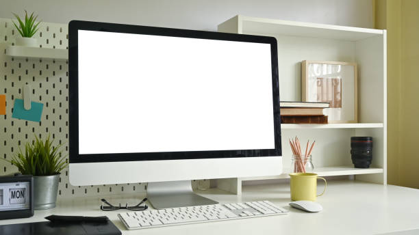 istock Workspace mockup computer, pegboard, shelves and office supply on creative office desk. 1171030110
