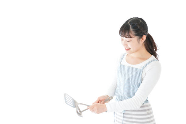 istock Young woman cooking something with smile 1171036155