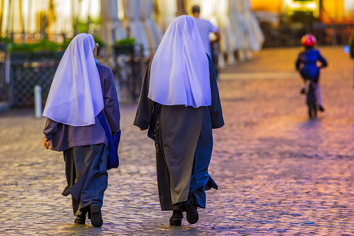 The historic city of Rome in the Italian province of Lazio on November 07, 2013: Nuns walking down the cobbled streets of the Centro Storico area of Rome Italy