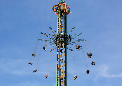 Copenhagen, Denmark - June 24, 2019: Star Flyer carousel in Amusement Park, Tivoli Gardens, view on the decorative top