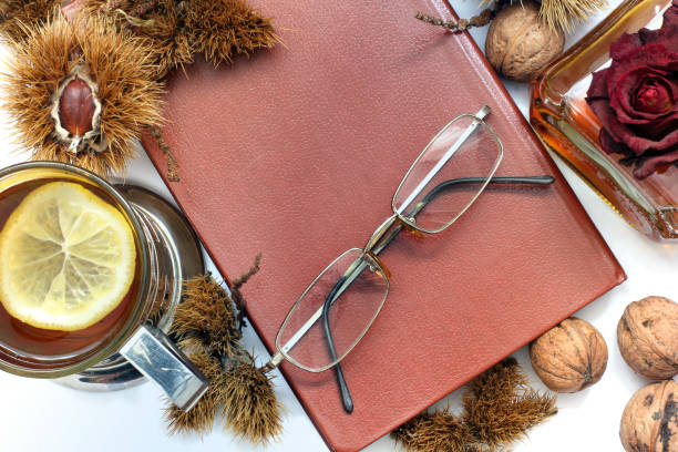 istock Composition. Cognac, a closed book, glasses and chestnuts 1171047976