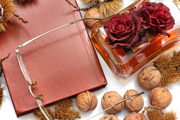 istock Composition. Cognac, a closed book, glasses and chestnuts 1171048040